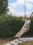 Opening of the new play equipment July 2019 - Cllr Bartle tries out the new zip wire